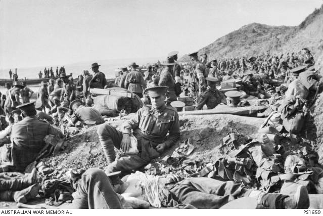 Wounded troops on the beach at Anzac Cove on 25 April 1915. Men of the AAMC are treating some of the wounded.